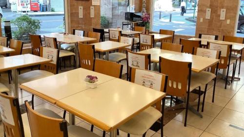 a row of tables and chairs in a restaurant at Toyoko Inn Wako-shi Ekimae in Wako