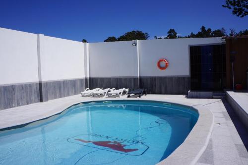 a swimming pool with a painting on the side of it at Casinha das Bonecas - Casa com Piscina Privada in Aveiro