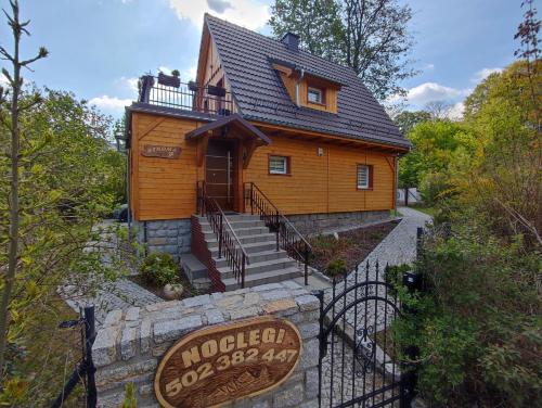 a small house with a sign in front of it at Sosnowa Chata - dom z prywatną sauną in Szklarska Poręba