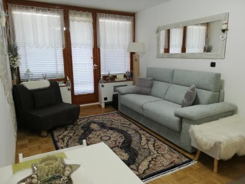 a living room with a couch and a chair at Condominio - Guglielmo Tell in Sestriere