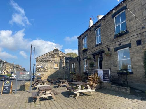 a group of picnic tables outside of a building at The White Swan, Yeadon in Yeadon