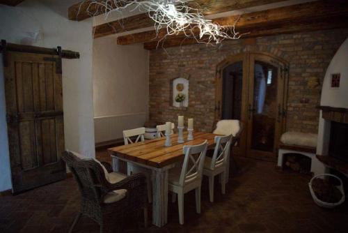 a dining room with a wooden table and chairs at Koňsky ap in Pouzdřany