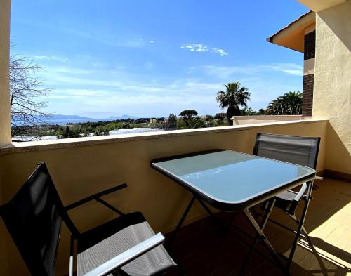 a table and chairs on a balcony with a view at Villa Viuli in Torre del Greco