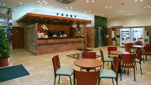 a restaurant with tables and chairs and a counter at Toyoko Inn Ichinoseki Ekimae in Ichinoseki