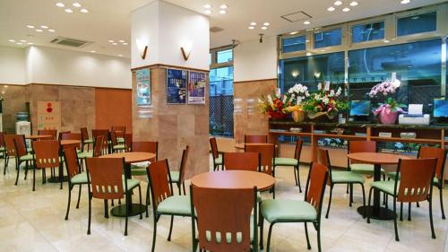 a dining room with tables and chairs in a restaurant at Toyoko Inn Ichinoseki Ekimae in Ichinoseki