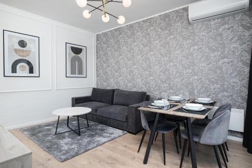 a living room with a couch and a table at Golden Gate apartment in Pula