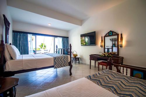 A bed or beds in a room at Bamburi Beach Hotel