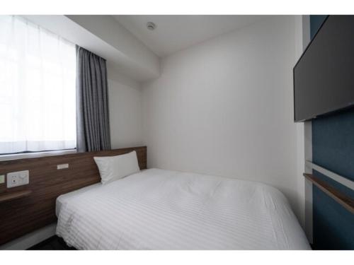 Säng eller sängar i ett rum på R&B Hotel Sendai Higashiguchi - Vacation STAY 39921v