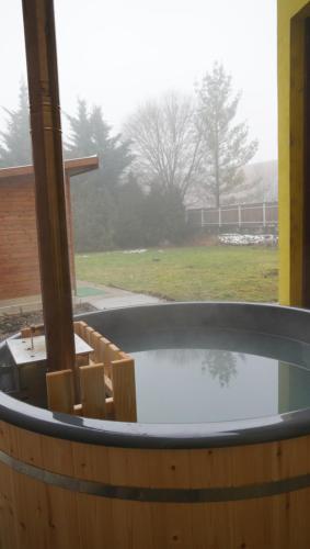 eine Whirlpool-Badewanne mit Blick auf ein Feld in der Unterkunft Pajkos Póni Vendégház in Miskolc