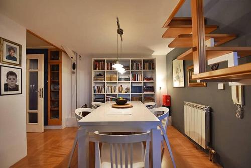 a kitchen with a table and chairs in a room at Central Park Gallery in Sarajevo