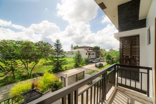 a balcony with a view of a yard at Bella Homes 6BR 4Bath near Rotunda in Tagaytay