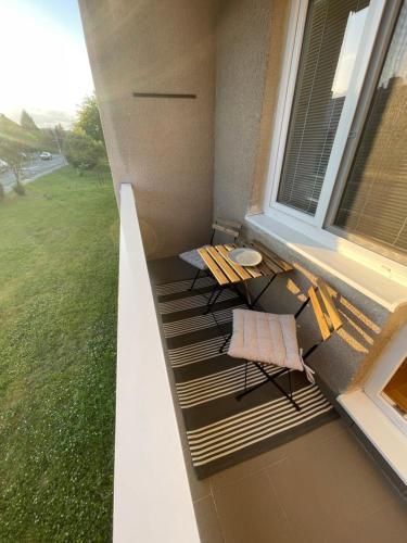 einen Balkon mit einem Tisch und Stühlen sowie einem Fenster in der Unterkunft apartmán NA NOC V BOHDANČI in Lázně Bohdaneč