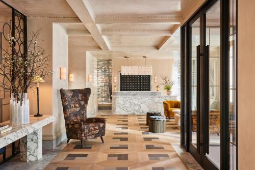 a lobby with a chair and a fireplace at The Wall Street Hotel New York City in New York