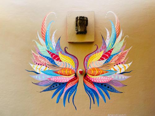 a painting of a colorful butterfly on a lightswitch at Casa Boho 1 in Sayulita