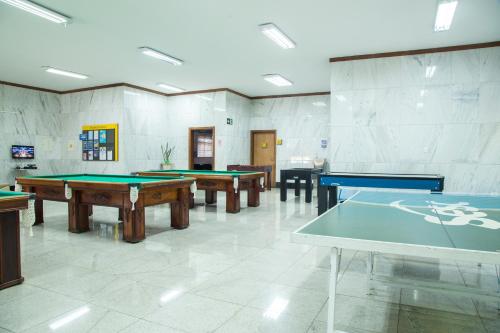 una habitación con 4 mesas de ping pong. en Sesc Venda Nova, en Belo Horizonte