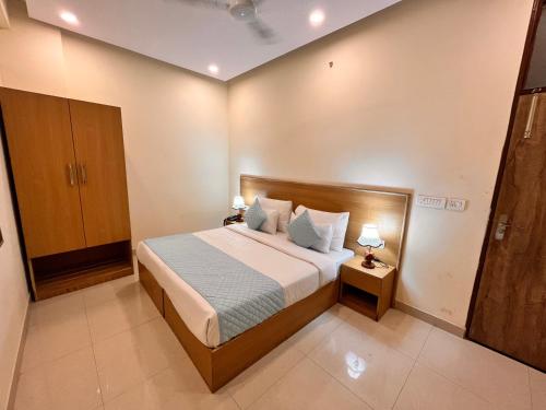 a bedroom with a bed and two lamps on tables at HOTEL TNCS - Couple Friendly Local IDs Accepted in Noida