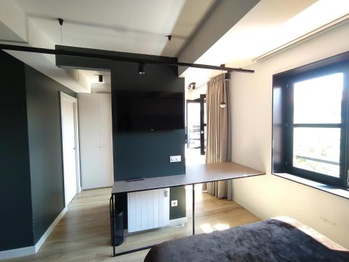 Televizors / izklaižu centrs naktsmītnē Apartamentos Puerta de Llanes