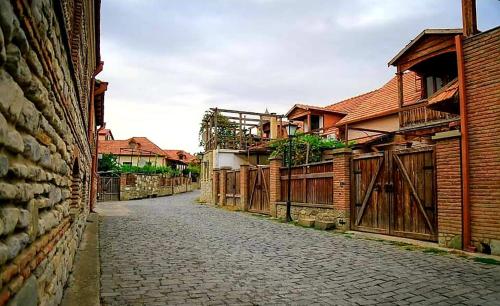 an empty street with a bunch of brick buildings at Levanto in Mtskheta