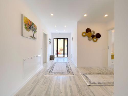 an empty hallway with white walls and wood floors at Vila Rolizo in Braşov