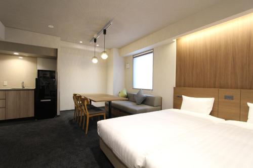 Ліжко або ліжка в номері KOKO HOTEL Residence Asakusa Tawaramachi