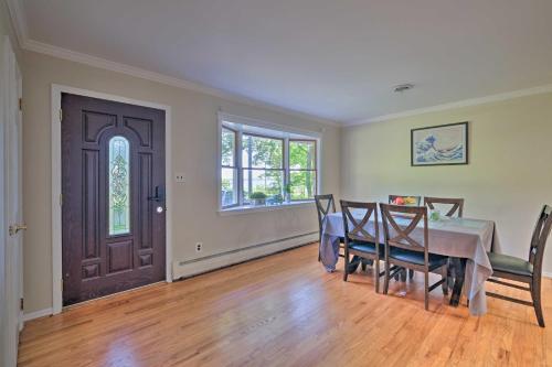 a dining room with a table and chairs and a door at Coastal Edgewater Home with Private Hot Tub! in Annapolis