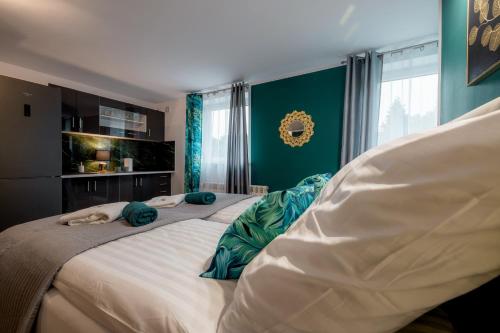 a bedroom with two beds with green walls at Eromeni Apartments in Biały Dunajec