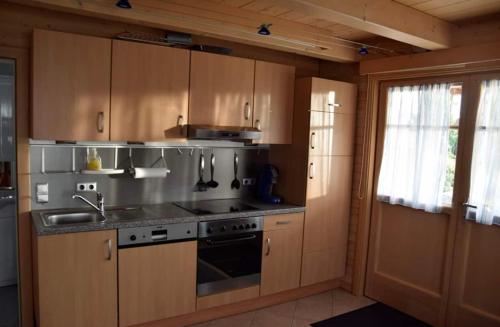 a kitchen with wooden cabinets and a stove top oven at Ruheoase in Wolfern, zw. Wien & Salzburg 