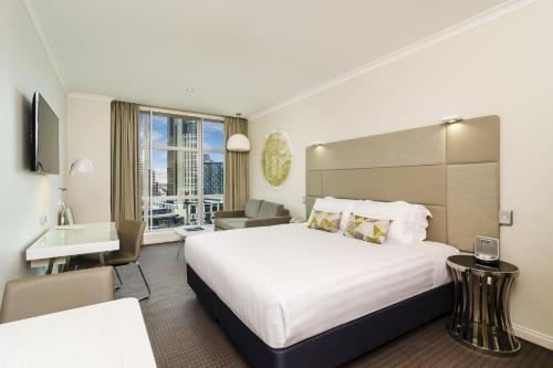 A bed or beds in a room at Clarion Suites Gateway