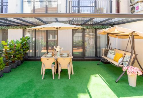 a patio with a table and chairs and umbrellas at Sevastopol apartments Varna in Varna City