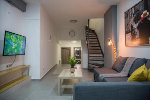 a living room with a couch and a table at BILLYS HOUSE in Tríkala