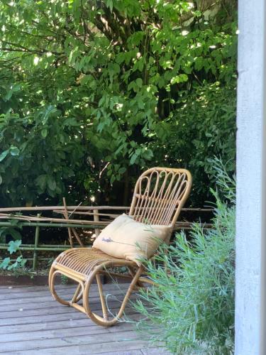 a rattan chair sitting on top of a deck at L'adresse à Besançon in Besançon