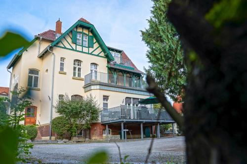 a large white house with a green roof at Traumhaft wohnen in Jugendstilvilla in Speyer