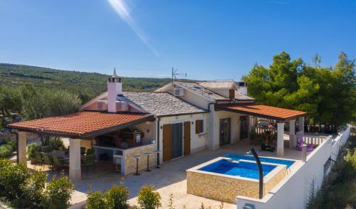 a house with a swimming pool in front of it at Villa Anabella in Supetar