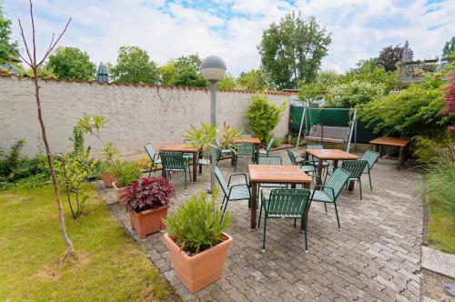 a patio with tables and chairs and plants at Radfahrerherberge Krems in Krems an der Donau