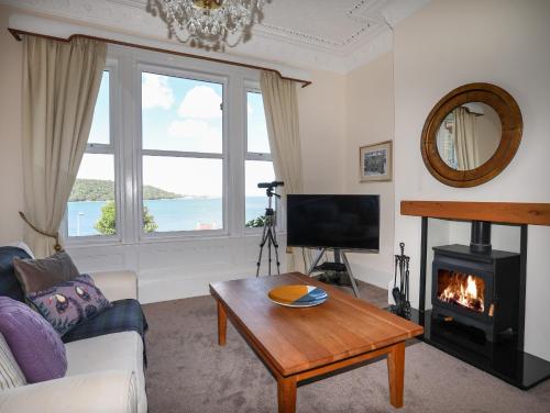 a living room with a couch and a fireplace at Bryn Ogwen in Bangor