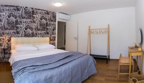 a bedroom with a bed and a wall mural at Rivus Apartments in Omiš