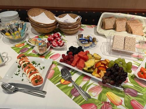 a table with sushi and fruits and plates of food at Hotel zur Altstadt in Celle