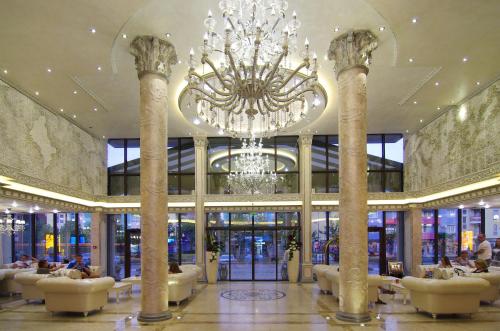 a large lobby with a chandelier in a building at Hotel & SPA Diamant Residence - All Inclusive in Sunny Beach