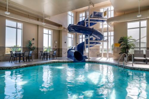 a swimming pool with a slide in a building at Best Western Plus Bridgewater Hotel & Convention Centre in Bridgewater