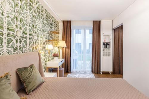 a hotel room with a bed and a large window at Lux Apartment With A Terrace In Vilnius Old Town in Vilnius