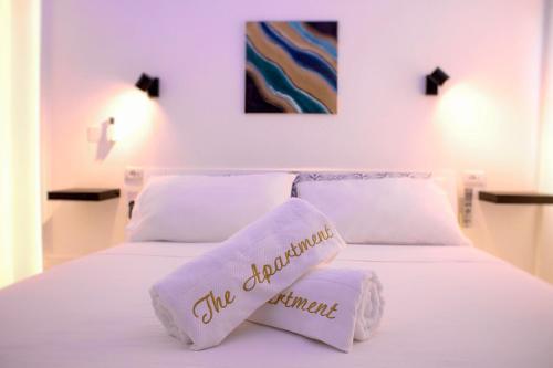 a white bed with two pillows on top of it at The Apartment in Porto Santo Stefano