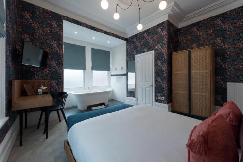 A bed or beds in a room at The Clarence Boutique Rooms