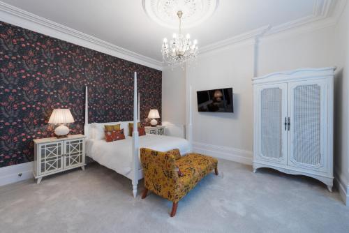 A bed or beds in a room at The Clarence Boutique Rooms