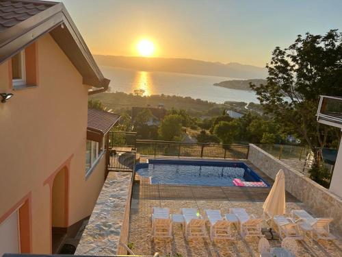 een villa met een zwembad en een zonsondergang bij Villa Aurora in Ohrid