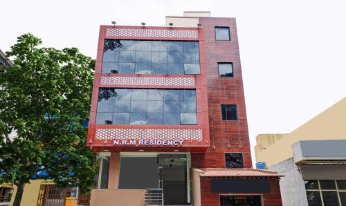 a red brick building with a main registry at Itsy Hotels NRM Residency in Mysore