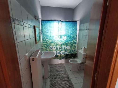 a bathroom with a sink and a toilet at Elli's House in Keramotí