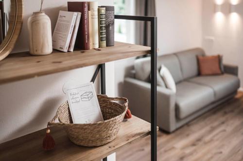 a shelf with books and a couch in a living room at apartments55 in Bressanone