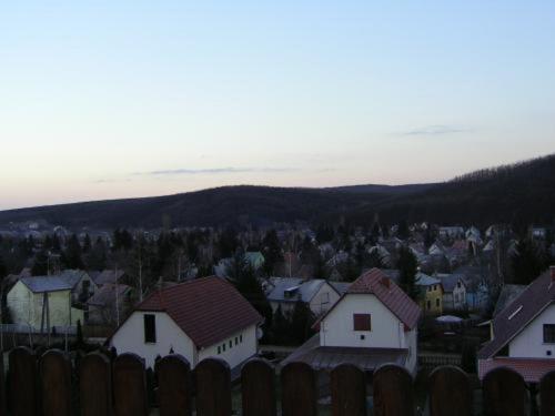 a group of houses in a town with a fence at Szigeti B&B in Bogács