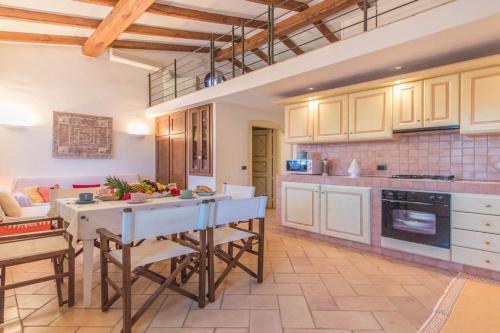 a kitchen with a table and chairs in a room at Sardinia Home in Palau