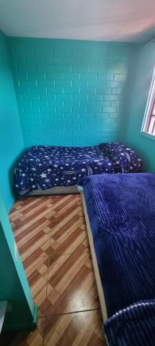 Tempat tidur dalam kamar di Casa Enea Pudahuel